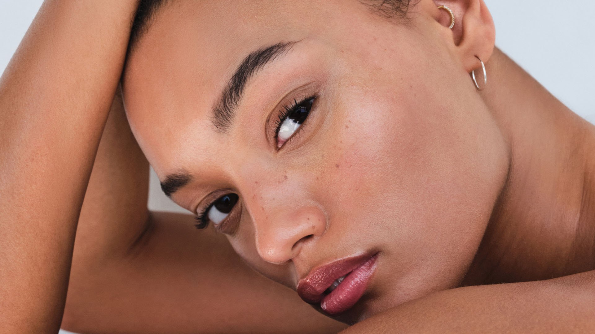 woman with flawless skin looks into camera while wearing Westman Atelier Vital Skin Foundation Stick (£62)