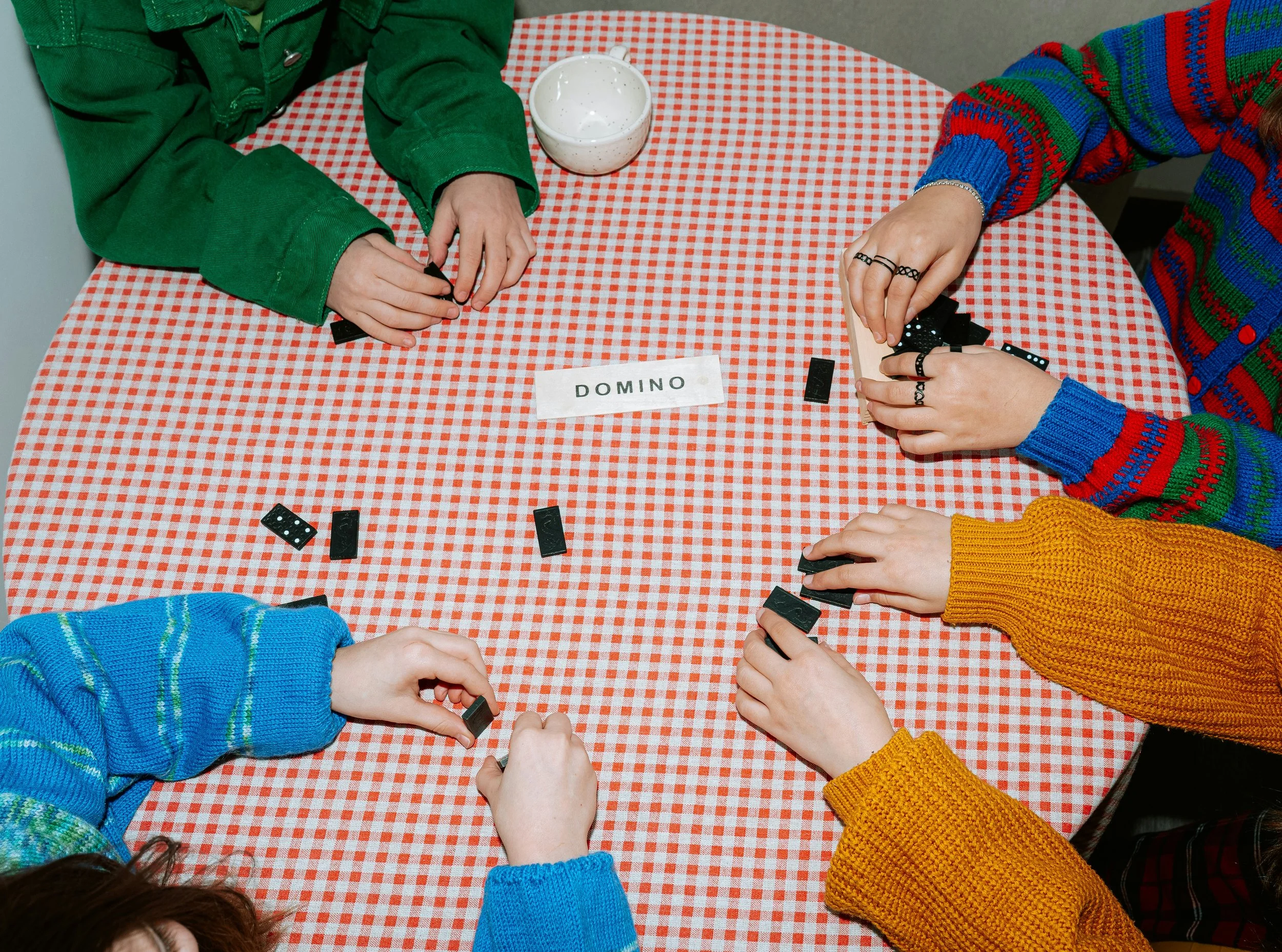 Children playing a thinking game around a table, showing different approaches to problem-solving and cognitive processing