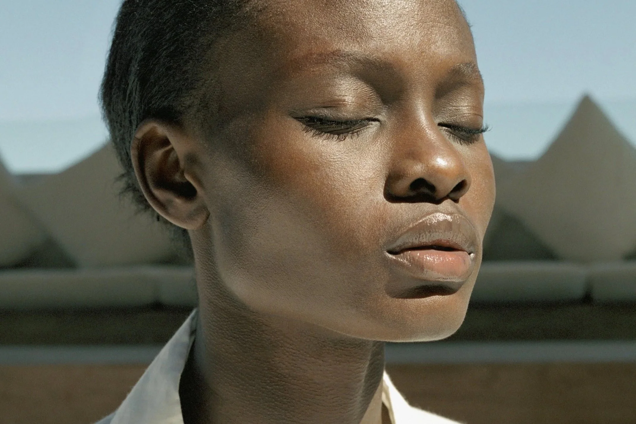 Woman using a lymphatic drainage facial tool to reduce puffiness and support circulation