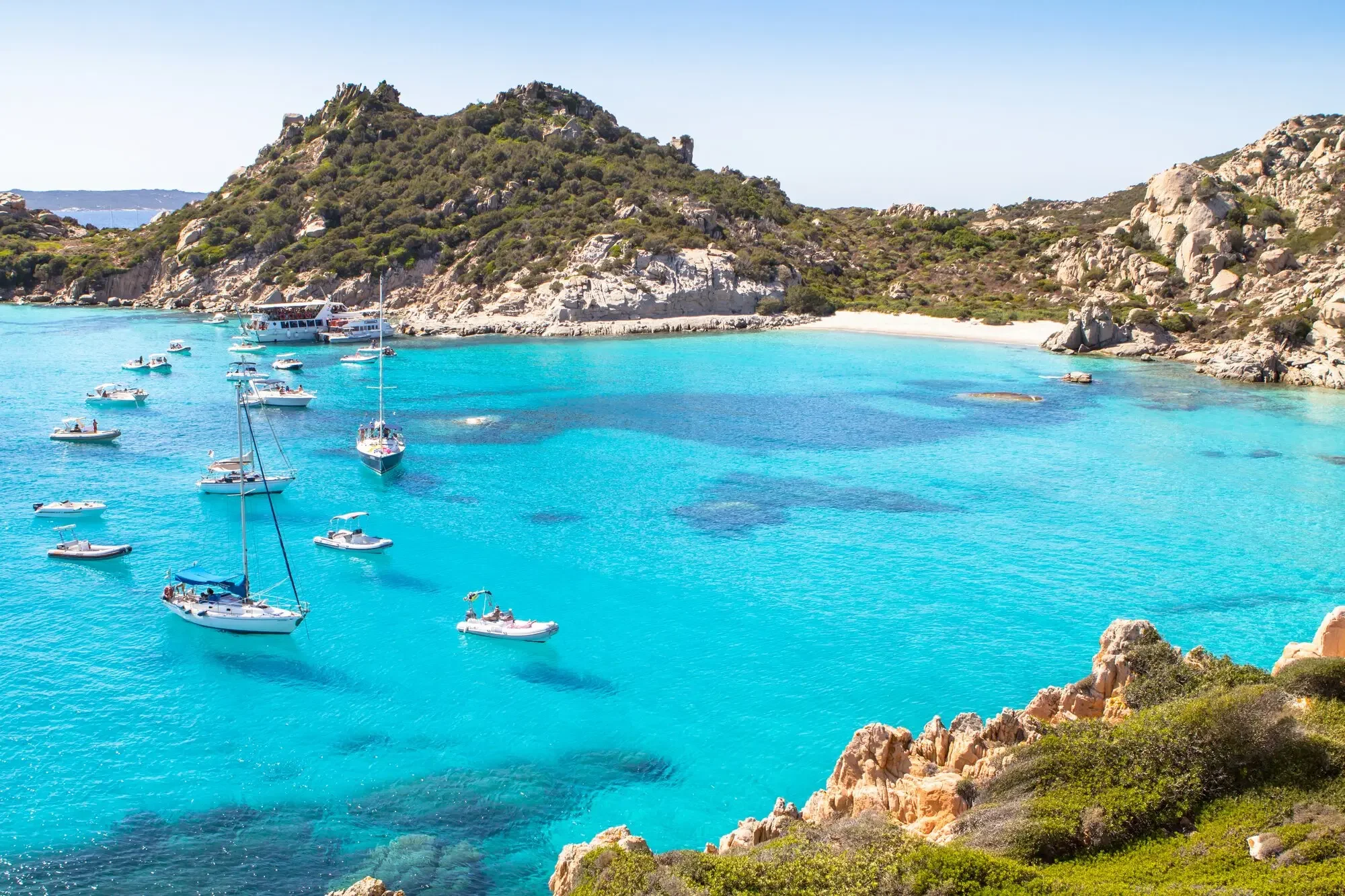 Turquoise bay and sailing boats in the La Maddalena archipelago, Sardinia.