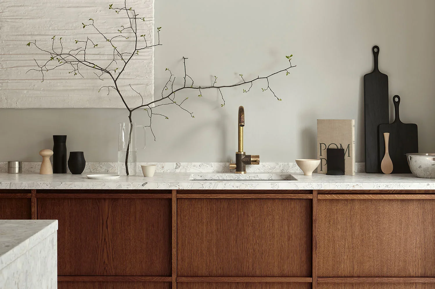 Dark wood kitchen with marble worktop, open styling and natural textures creating a warm, lived-in feel by Nordiska Kök