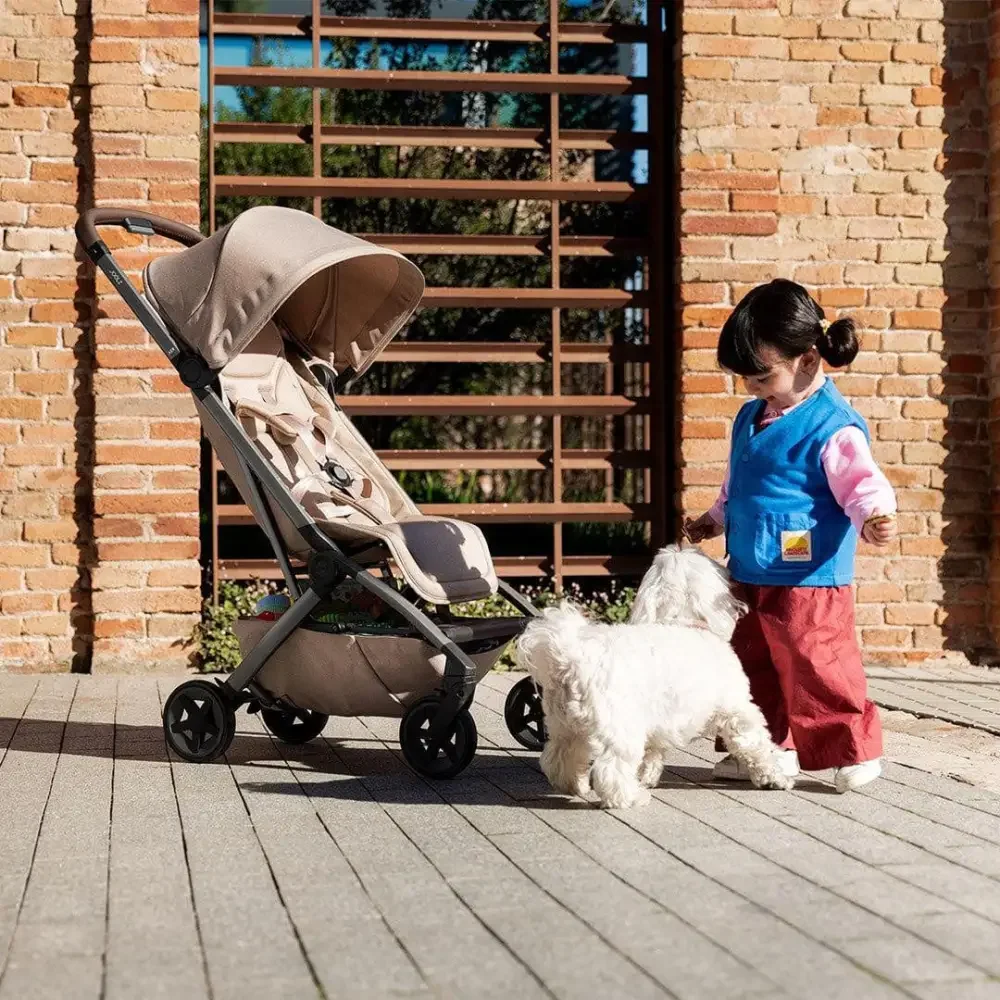 Toddler beside the lightweight Joolz Aer2 stroller outdoors showcasing the compact city-friendly design