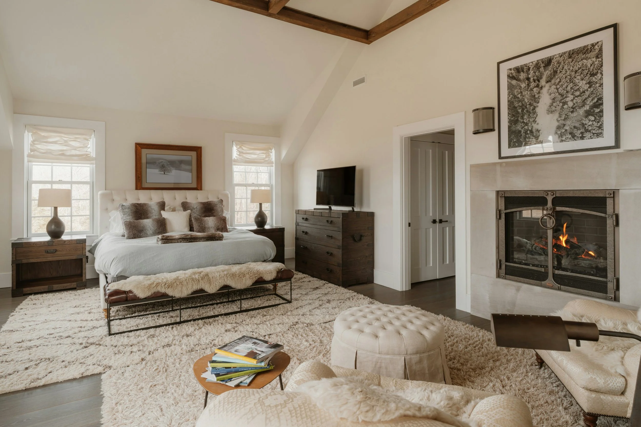 bedroom with fireplace and rugs