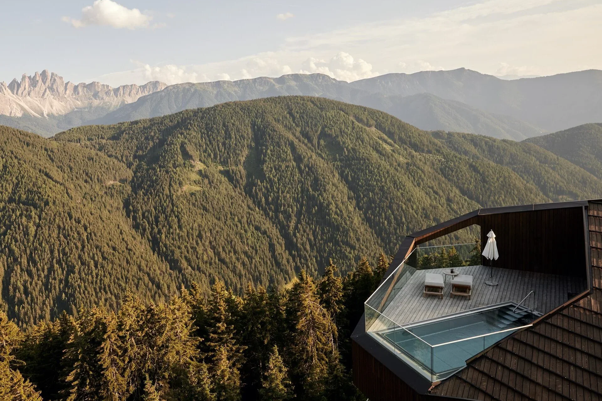 Forestis luxury mountain hotel terrace and infinity pool overlooking the Dolomites in South Tyrol, Italy