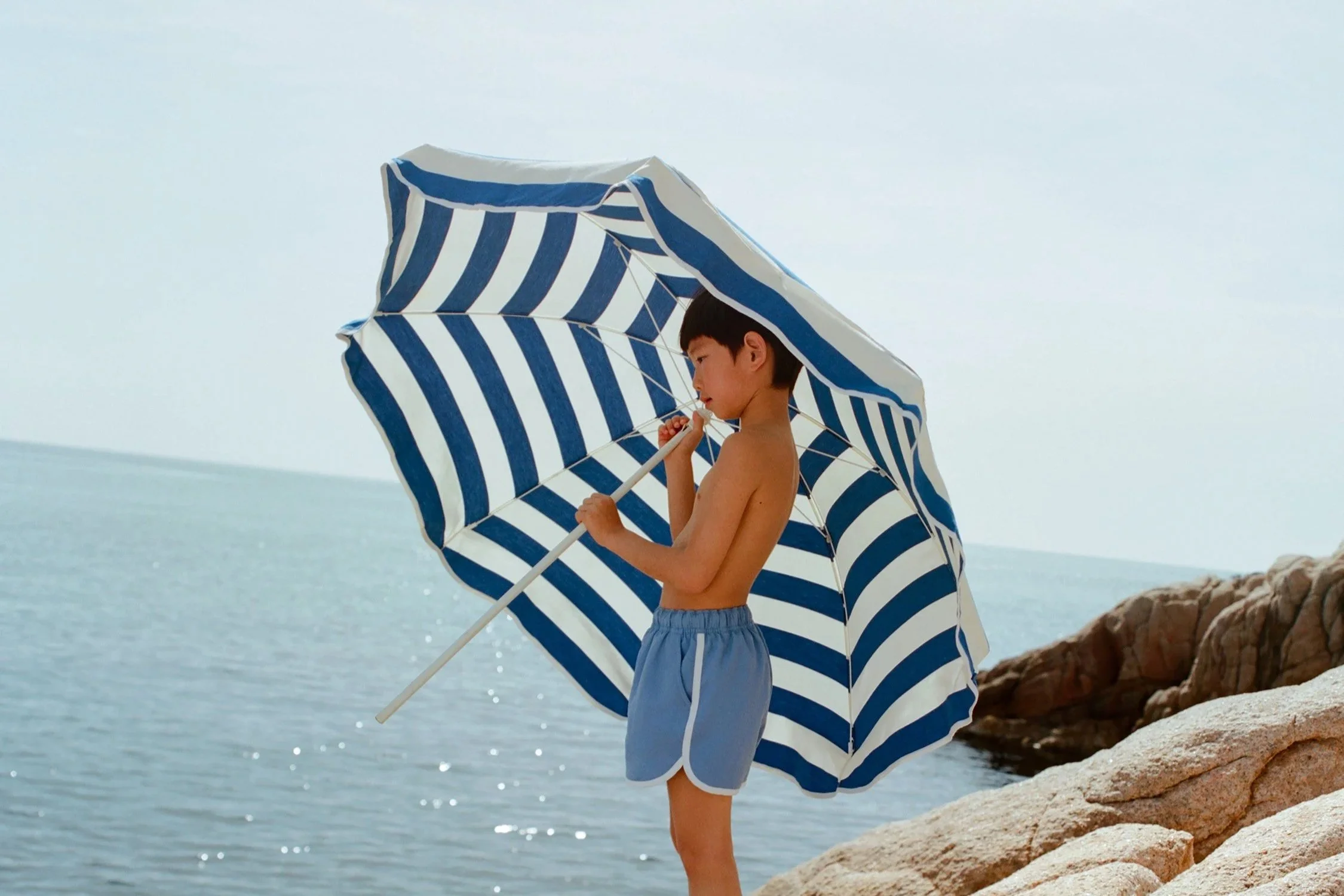 Arket children’s summer beachwear striped umbrella seaside kids holiday outfit lifestyle