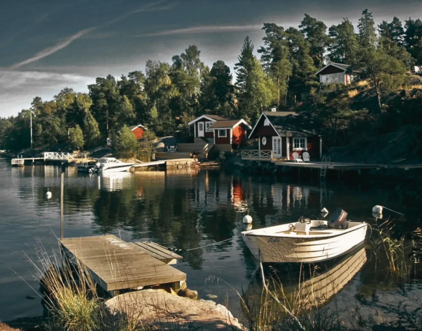 Red Scandinavian summer cabins beside the water in the Swedish archipelago