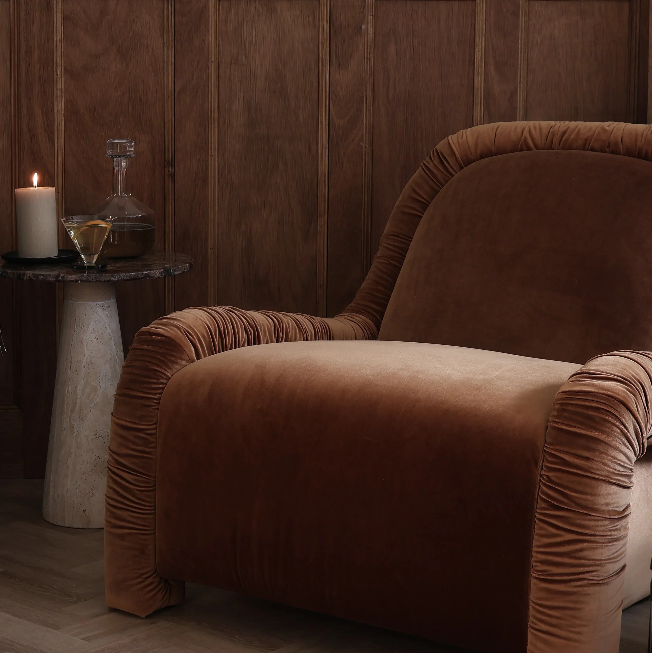 Six The Residence Ruched Lounge Chair. Curved ruched lounge chair in warm brown velvet, designed for comfort with soft edges and an inviting, relaxed silhouette