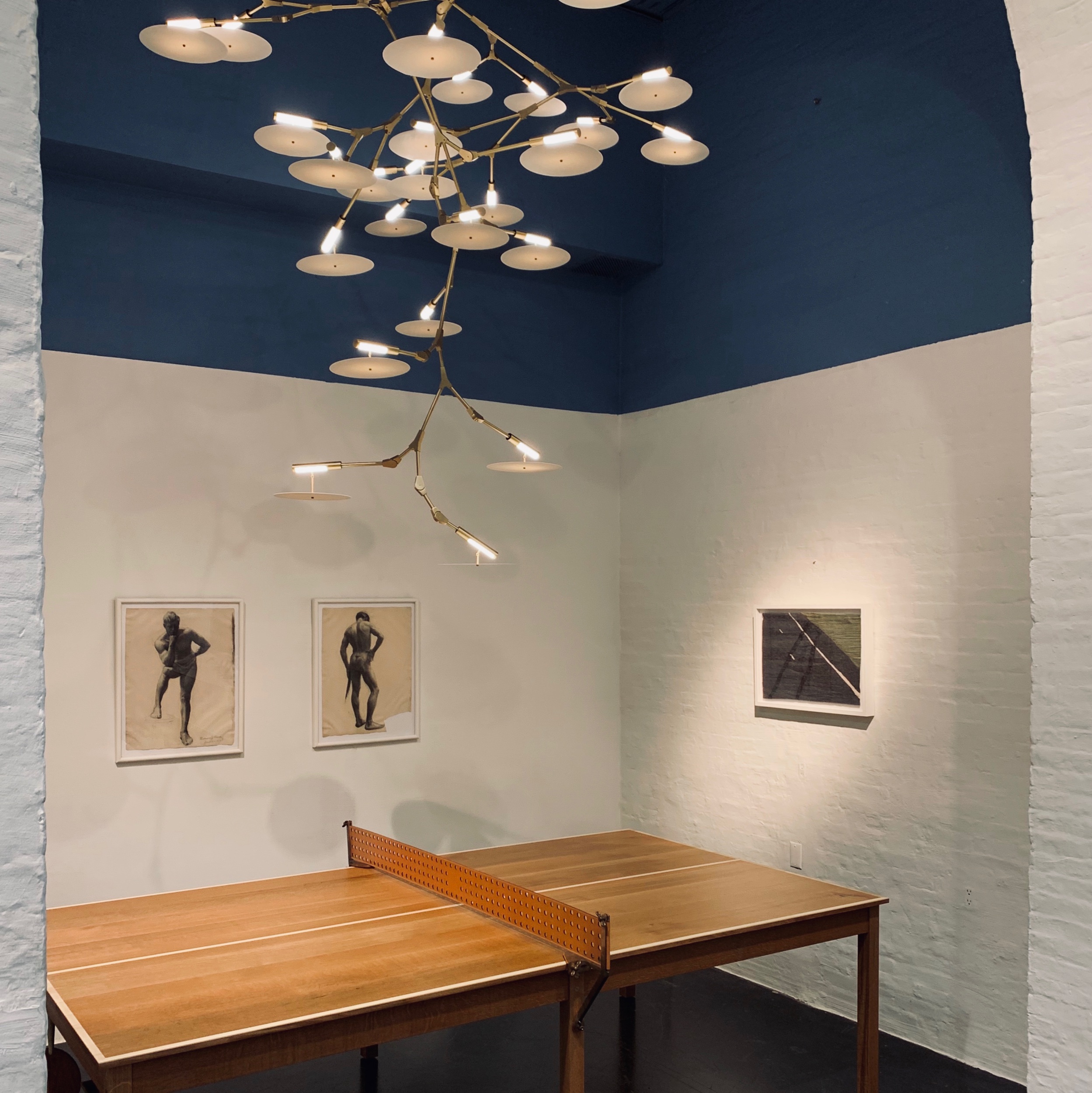 Tyler Hays Ping Pong Table under Lindsey Adelman Light Feature.