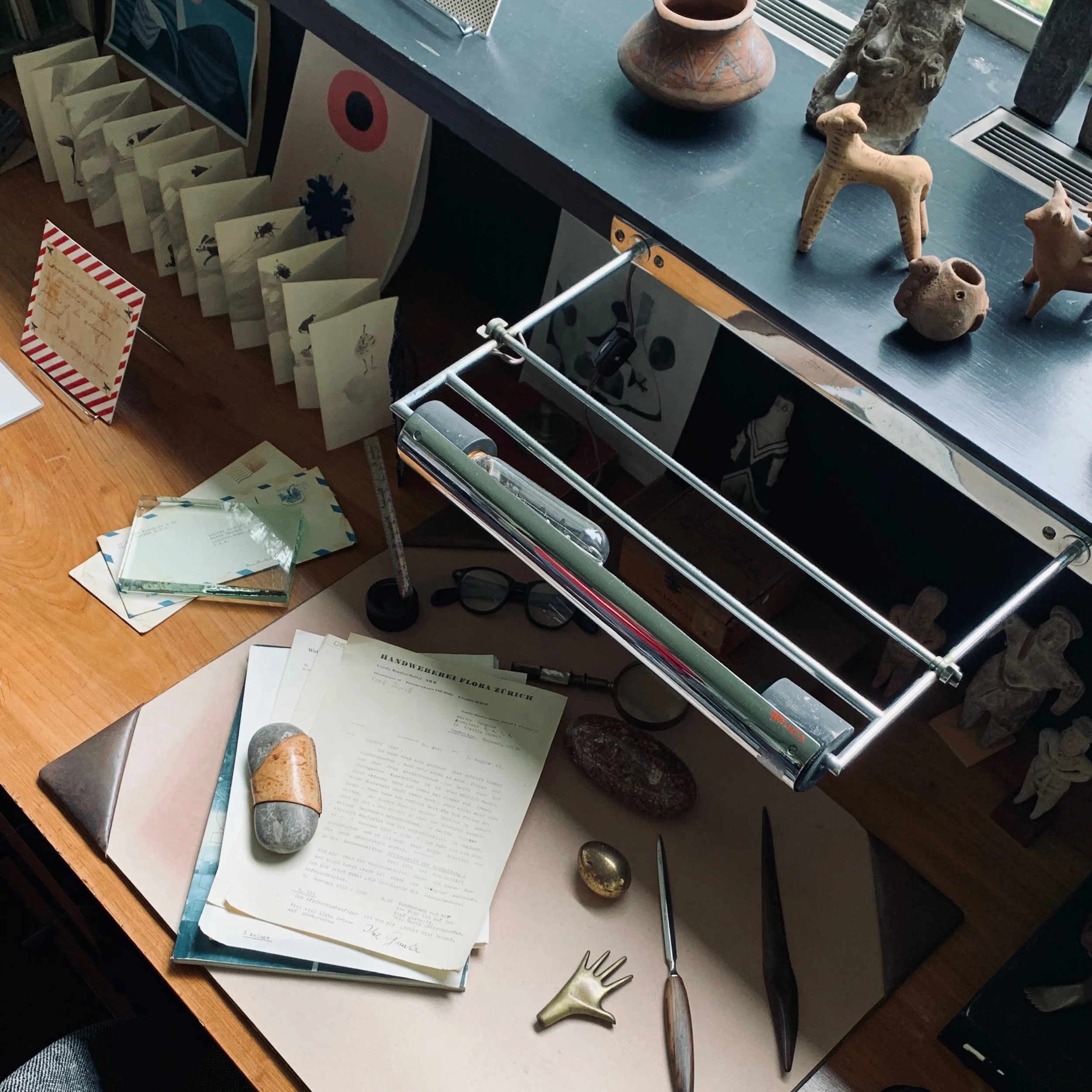 The desk of Walter Gropius, features lamps by Marianne Brandt and pre-Colombian artifacts from Diego Rivera and Frieda Kahlo.