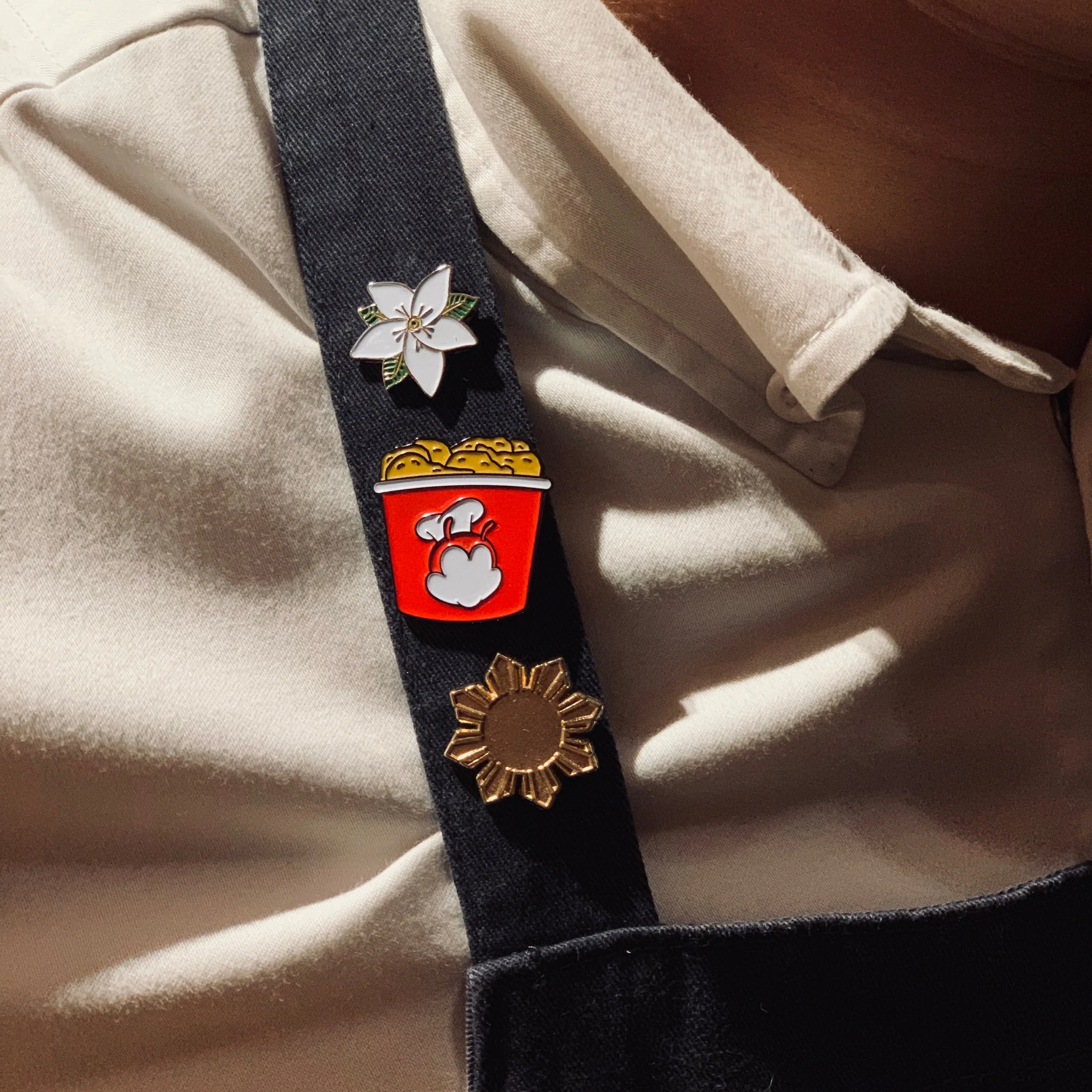 The Three things Chef John Rivera keeps close to the vest, the Sampaguita (Philippine’s national flower), the Jollibee Chickenjoy (a favorite of the late great Anthony Bourdain), and the Sun from the Philippine flag.