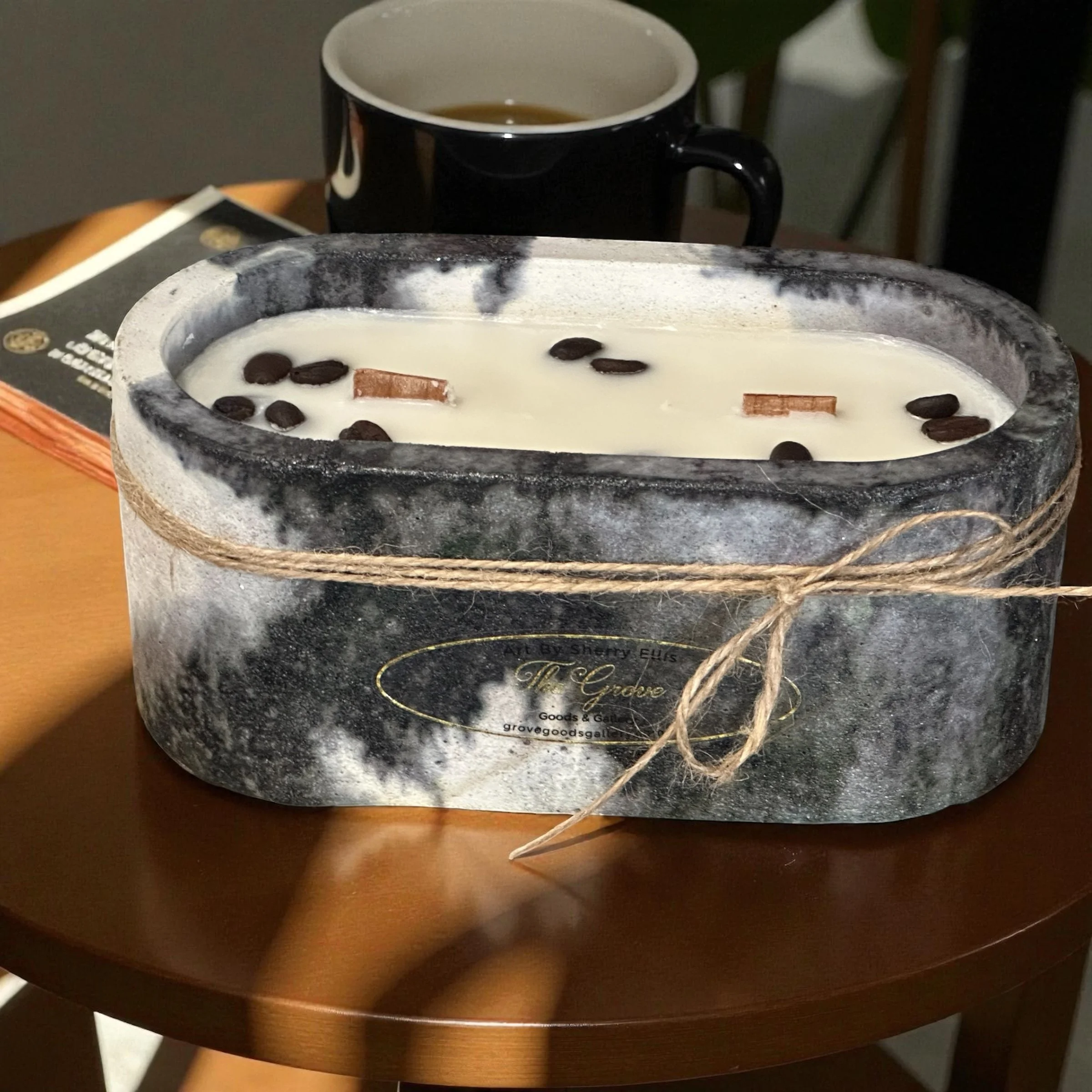 Hand-poured obround-shaped soy candle with wood wicks and coffee beans