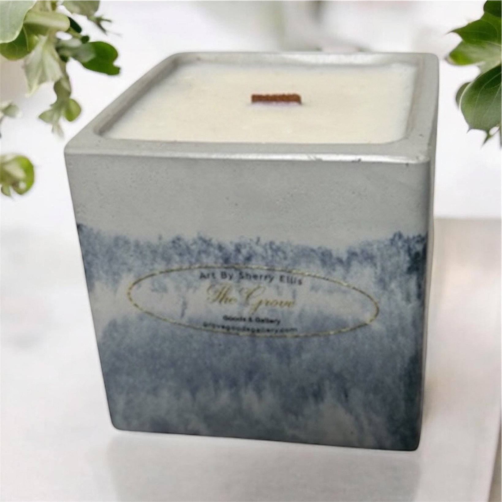 Large hand-poured soy wax candle with a wood wick and textured cement vessel.