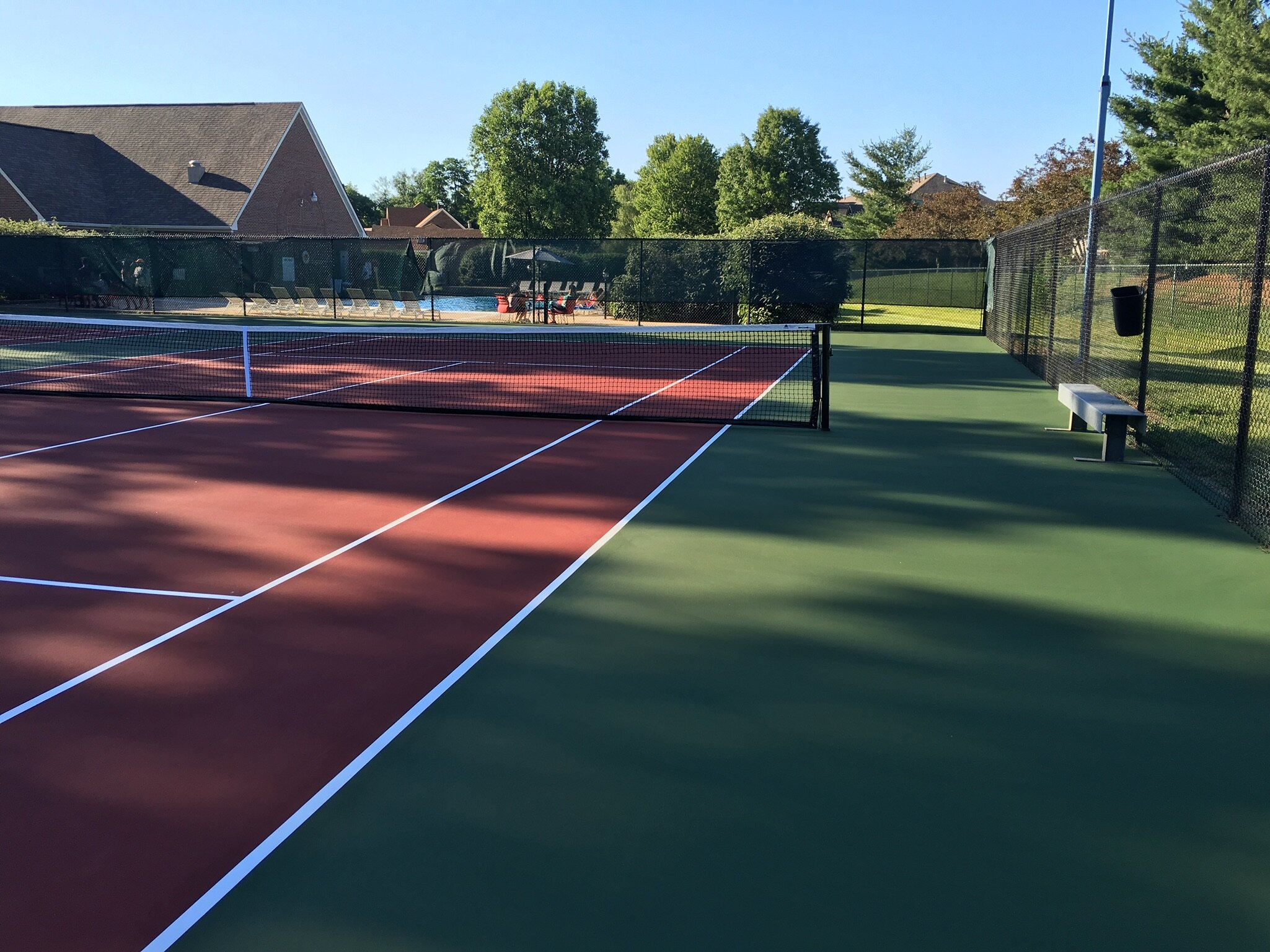 Red Tennis Court With Green Out of Bounds.JPG