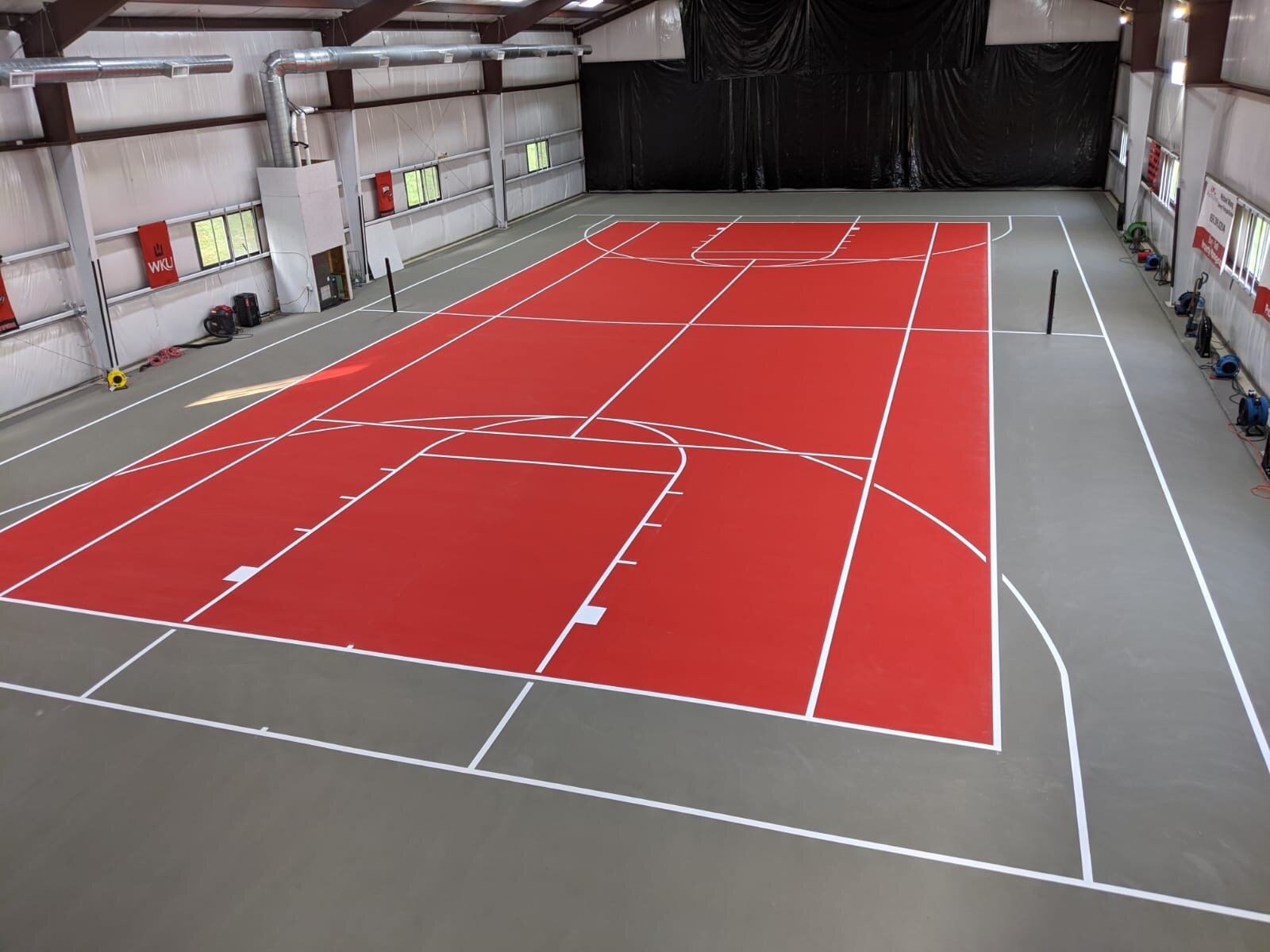 Bright Red Tennis Court with White Basketball Lines.JPG