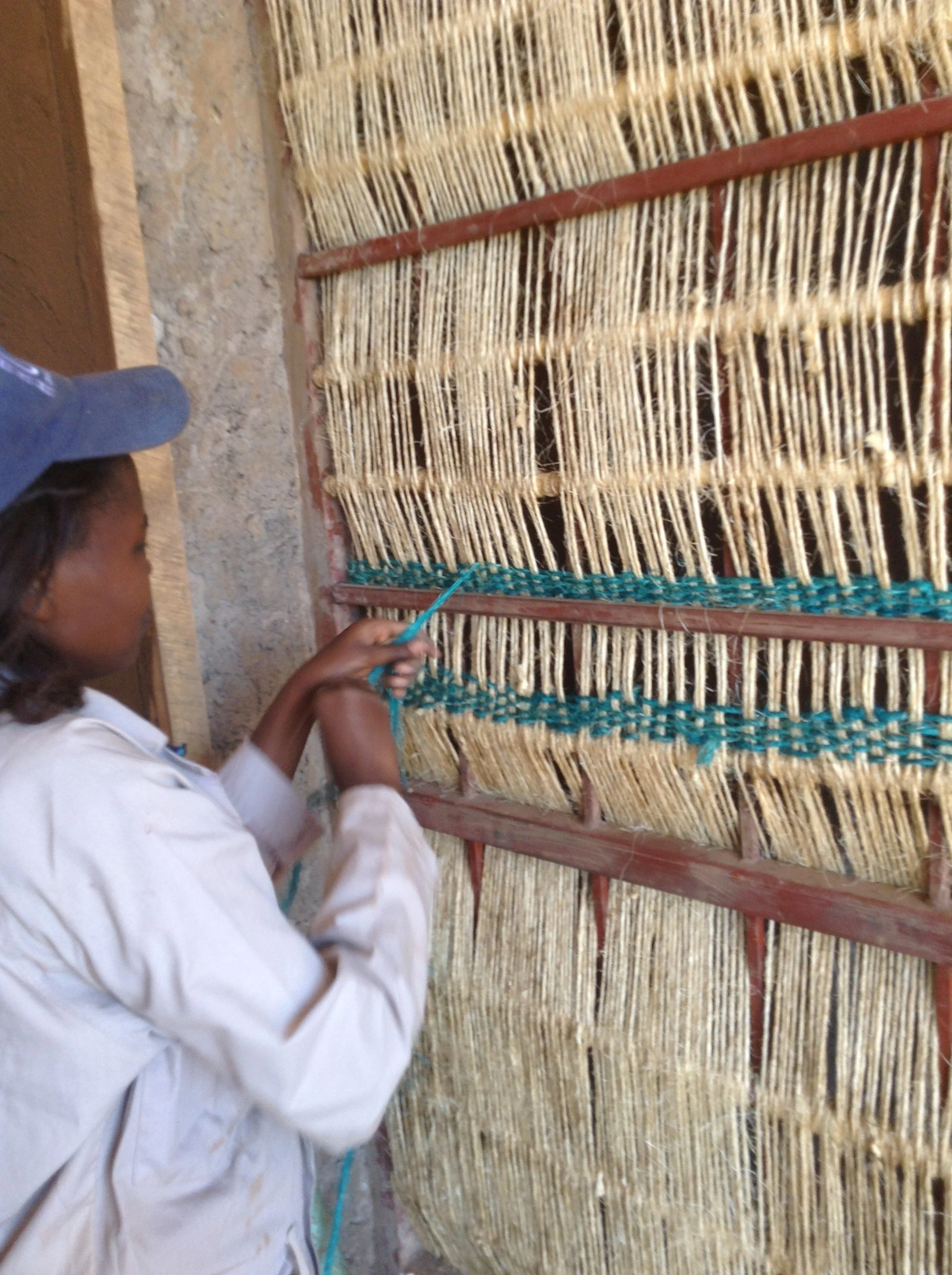 A hand-woven screen provides privacy for the cooking space. The use of vernacular materials and building practices in Rwanda is as much evidence of economic expediency as cultural concern. Image © Yutaka Sho