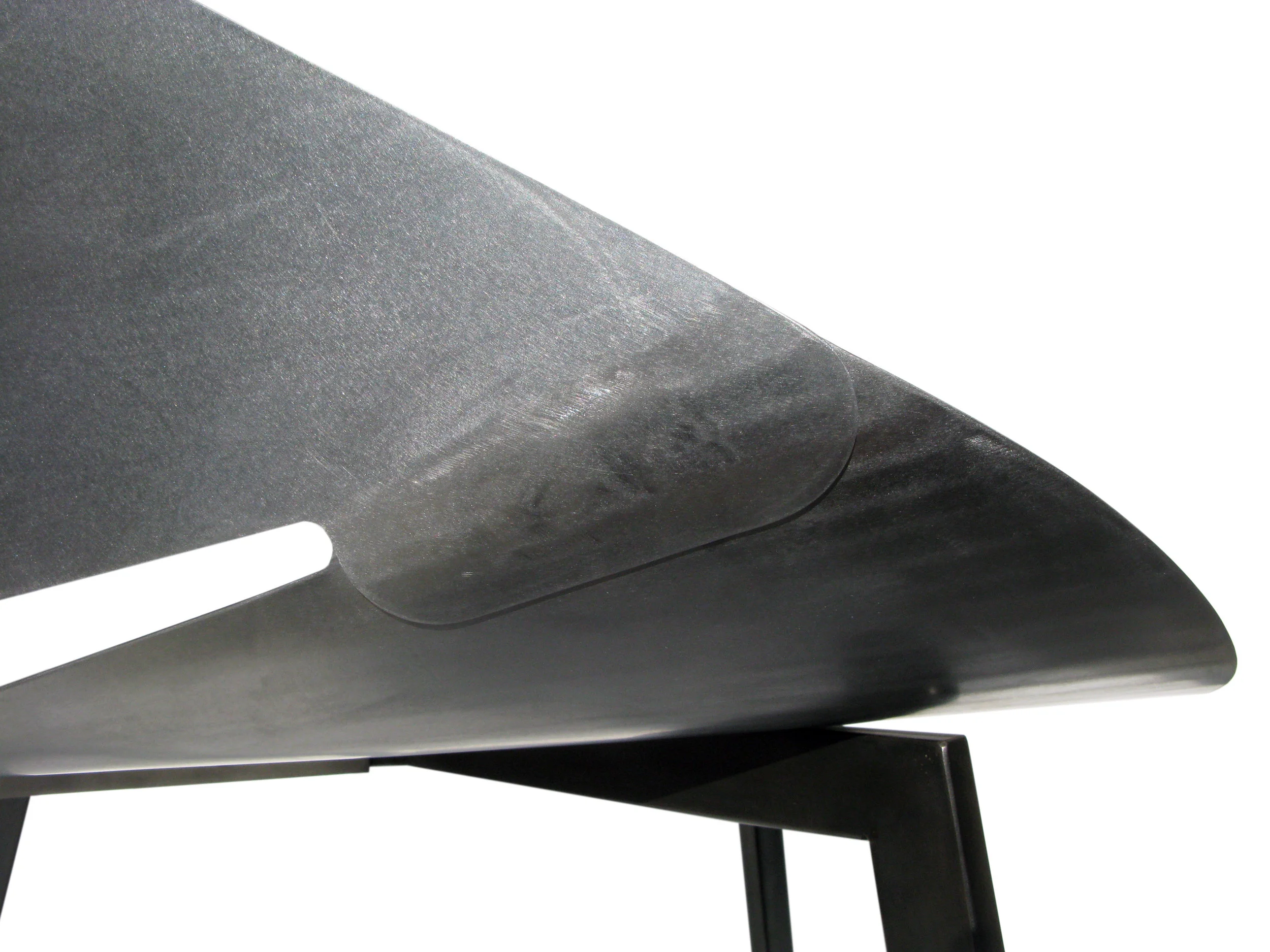 The back laps over the seat and places the two surfaces in tension