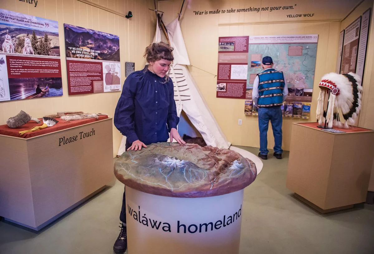 Exhibit artist JR Rymut of Echo Fabrication with her handmade topographical map of the Wallowa country.