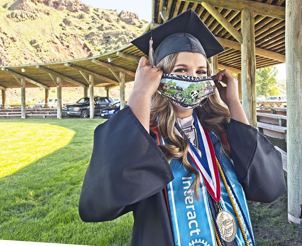  Wallowa Valedictorian Ashlyn Young wears a mask at the WHS graduation. The ceremony was outdoors, families stayed in their cars, and graduating seniors maintained recommended social distance throughout the ceremony.  