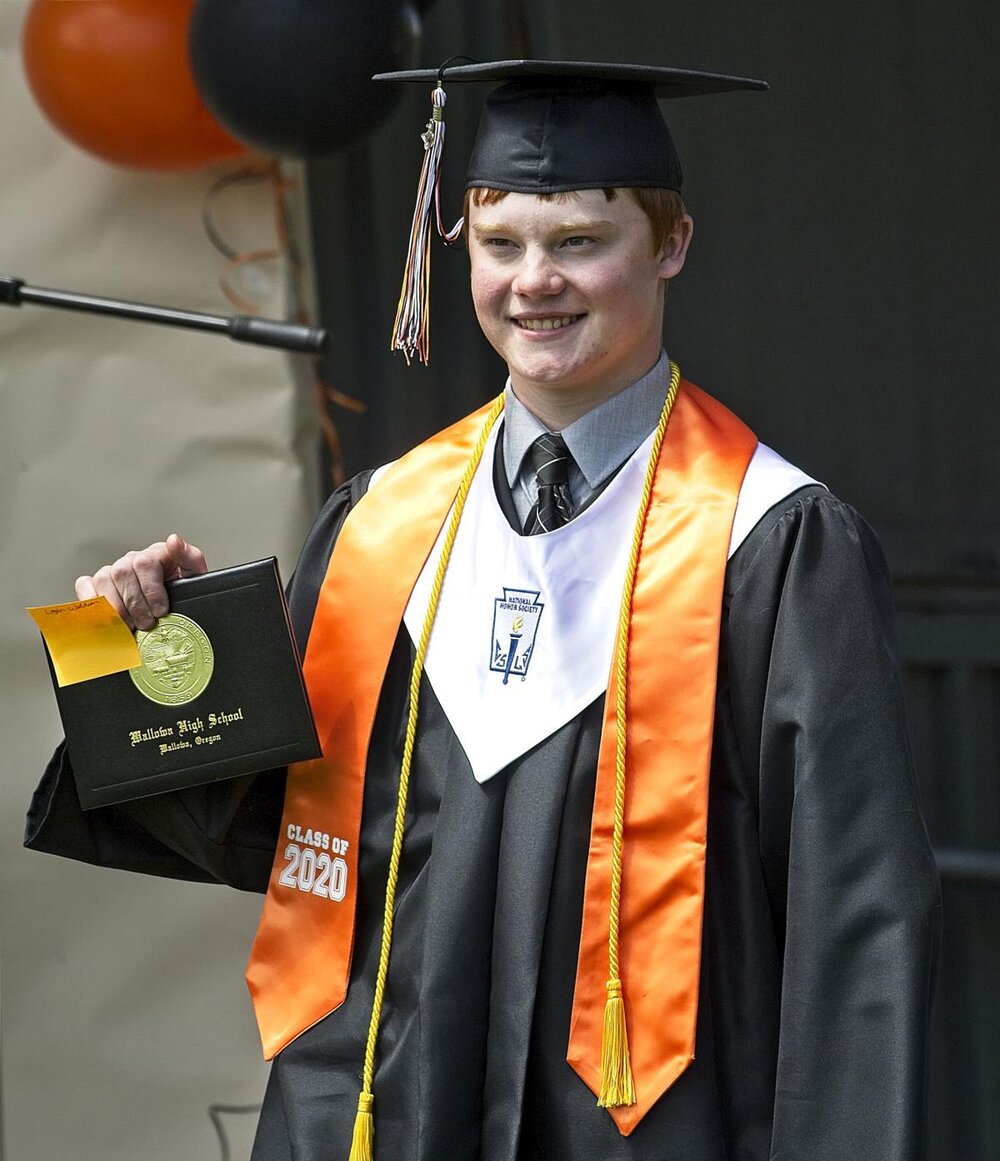  Class of 2020 President Logan Waldron shows off his newly minted diploma.  