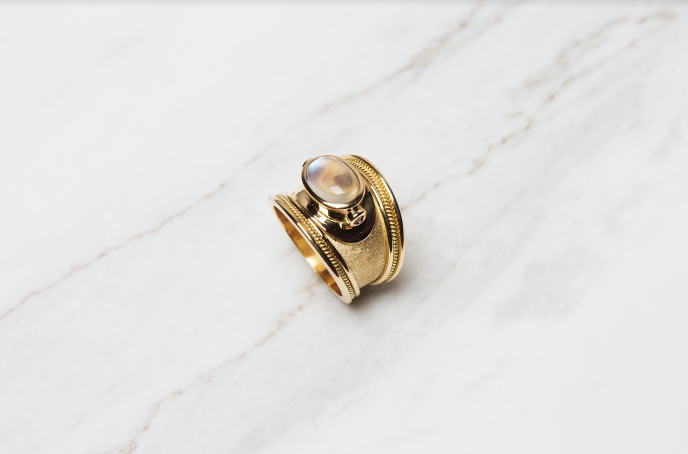 Moonstone gold ring with sapphire