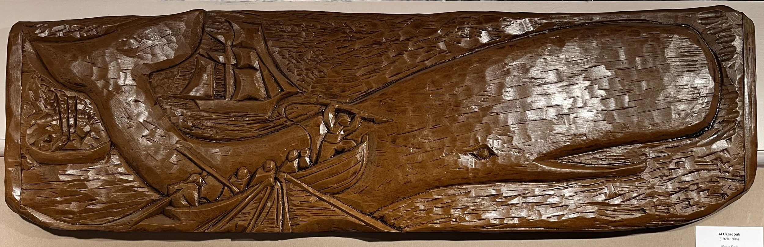   Al Czerepak (1928-1986)    Moby Dick   Wood Sculpture, 11 × 36.5 in. On Loan from the Town of Rockport Collection 