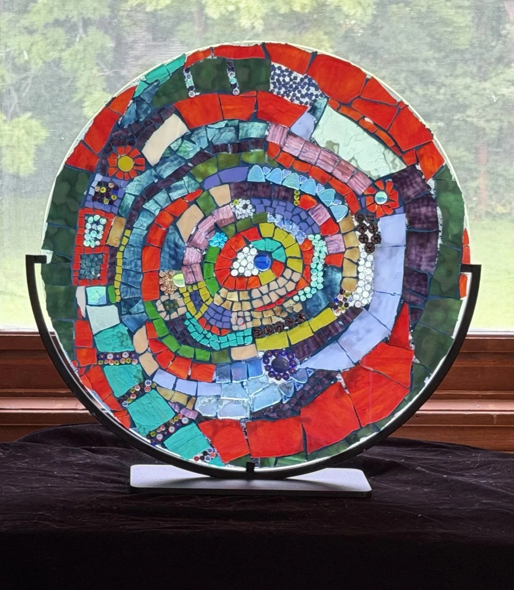   Cassie Doyon ,  Time Is A Wheel  Mosaic Glass Sculpture, 18 × 18 × 1 in. $600 