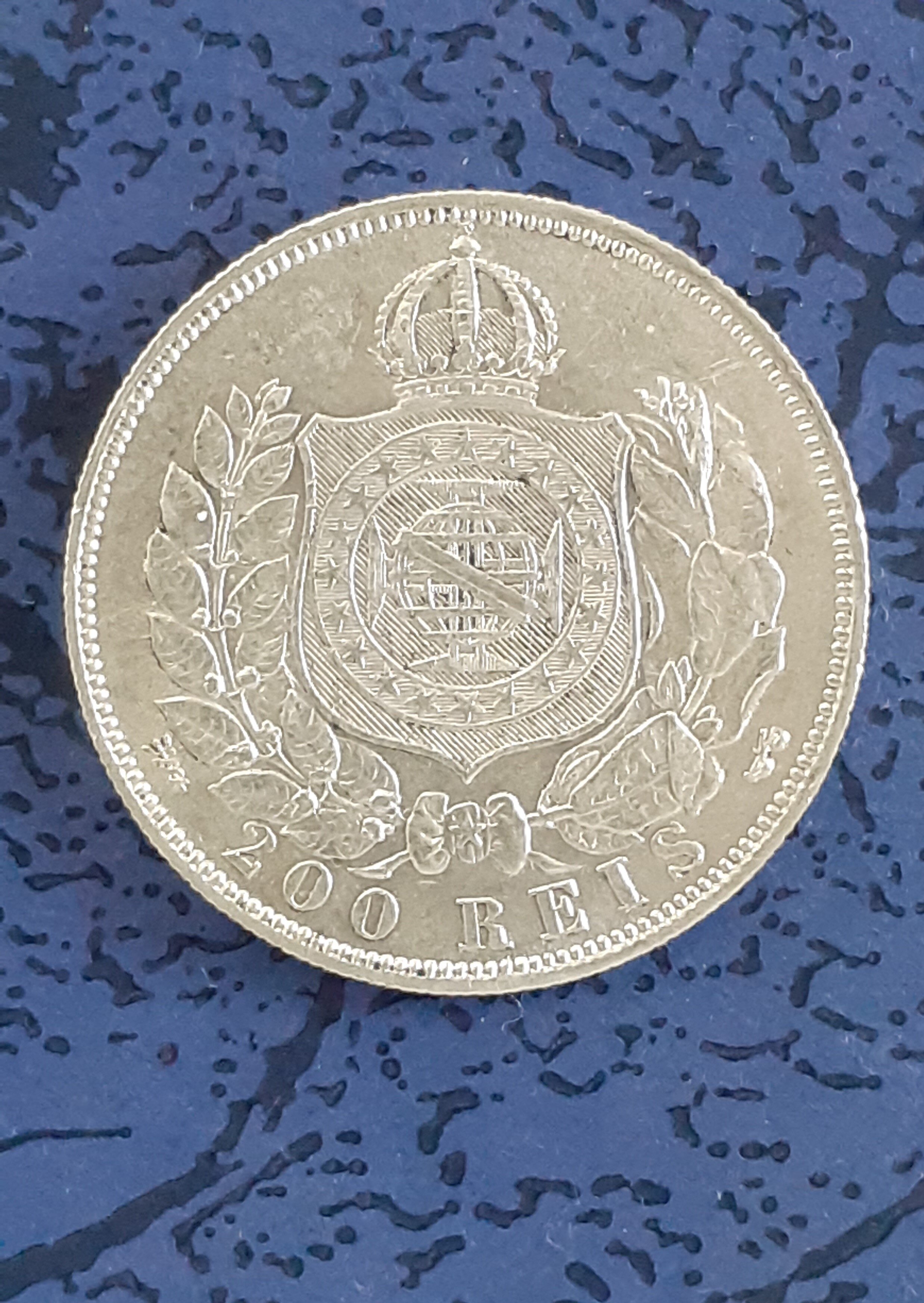 A Brazilian 1867 200 Reis Silver Coin.