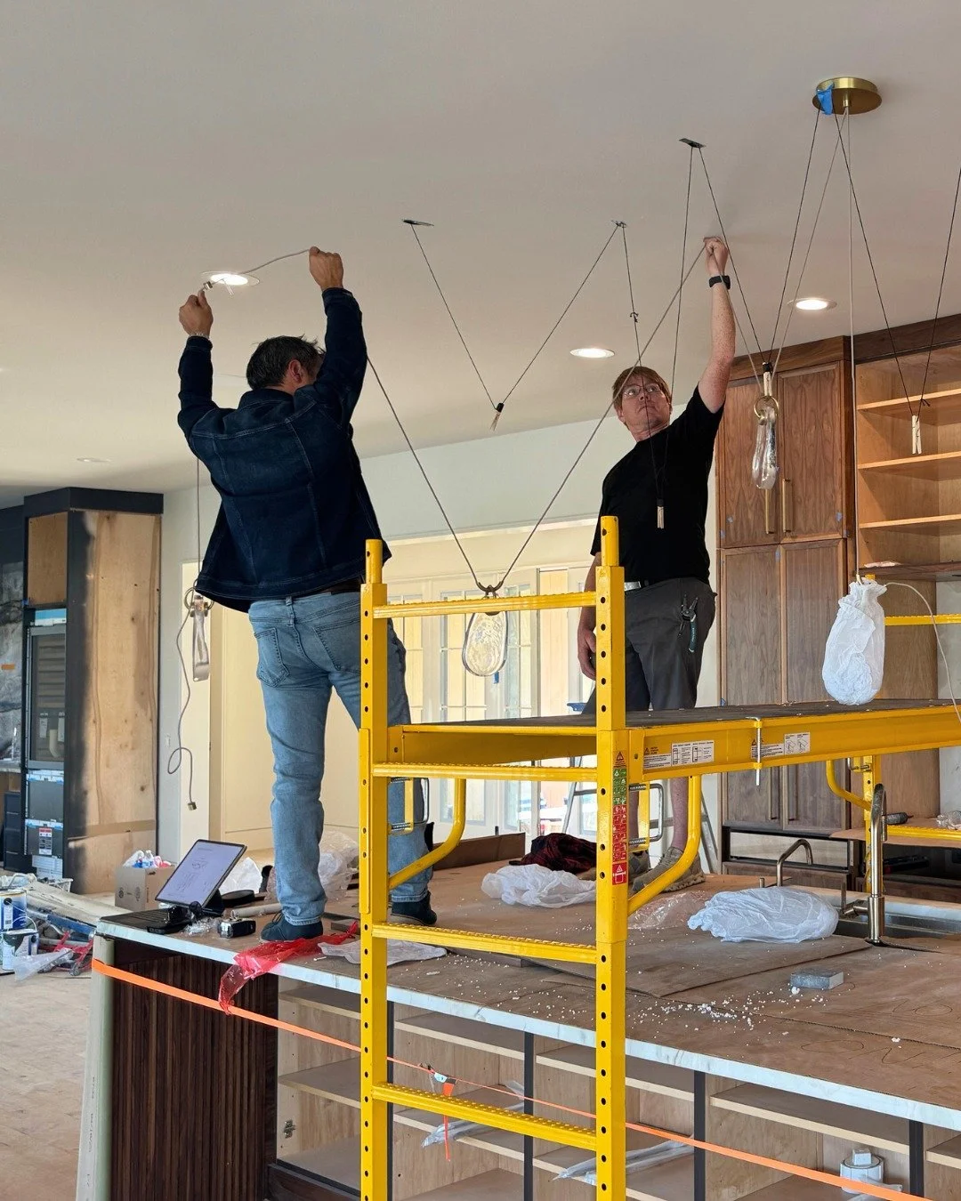 A behind-the-scenes look at Battery Place in Chattanooga, where lighting is currently being installed and carefully adjusted. 

Pendant lighting plays a key role in how this space will feel, particularly as it responds to the architecture and sweepin