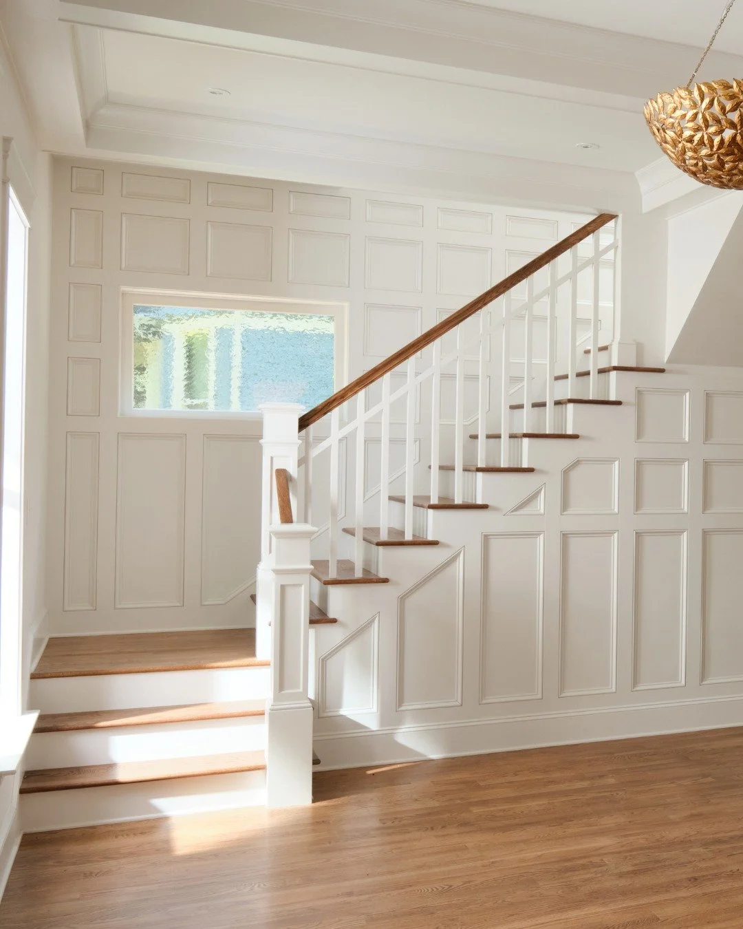A light-filled interior from the Vine Street project, a historic renovation in the Fortwood Historic Neighborhood.

Custom architectural millwork defines the space, wrapping the walls and Staircase in a continuous language of detail. The Staircase be