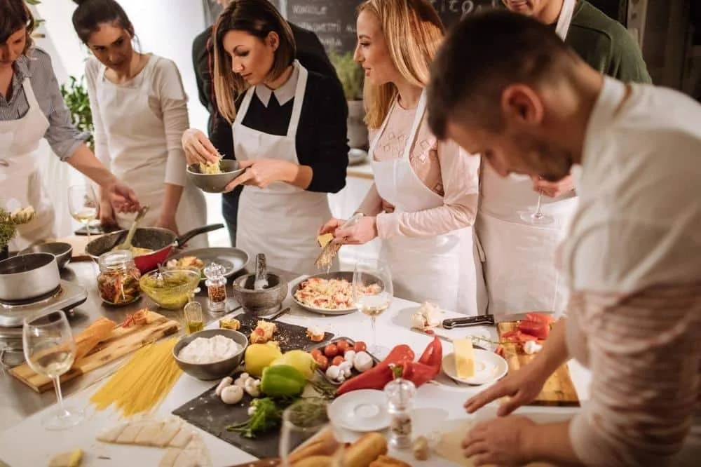 Friends preparing a meal together during a Kansas City cooking class