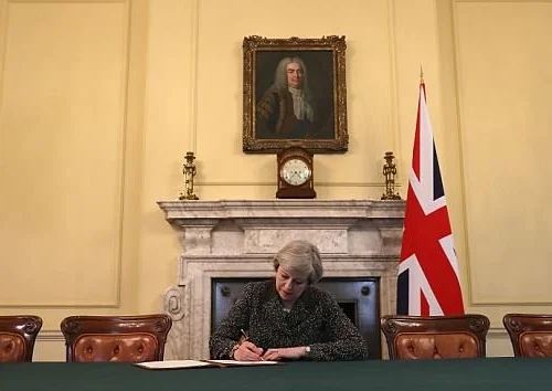 Theresa May writing the letter that triggered Article 50 in March 2017. An image that came to be parodied on levels not seen since Spitting Image.