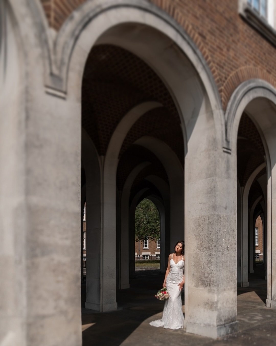 Capturing moments that are so beautifully genuine is such a privilege. This couple, in the simplicity of their embrace, speaks volumes about their connection. The light, the lines of the architecture and the intimate pause together&mdash;these are th