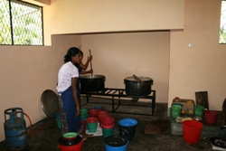 Getting ready to serve out the food into buckets for distribution to each class