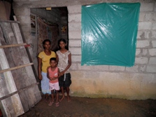 Anuthara with her family outside their home