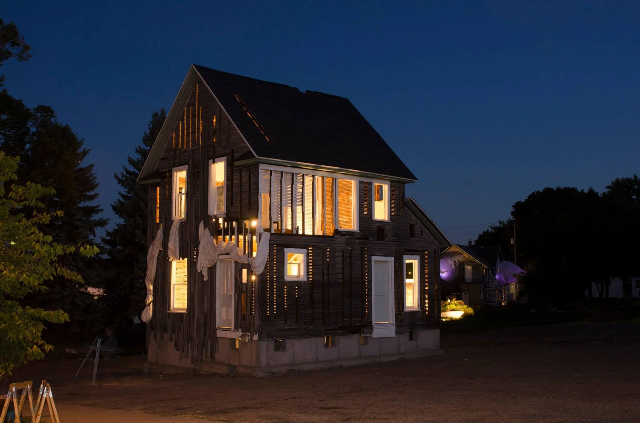 "TransMigration" illuminated at dusk