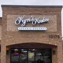 Sign for Kyrie's Kitchen, an organic gourmet restaurant, on a brick building