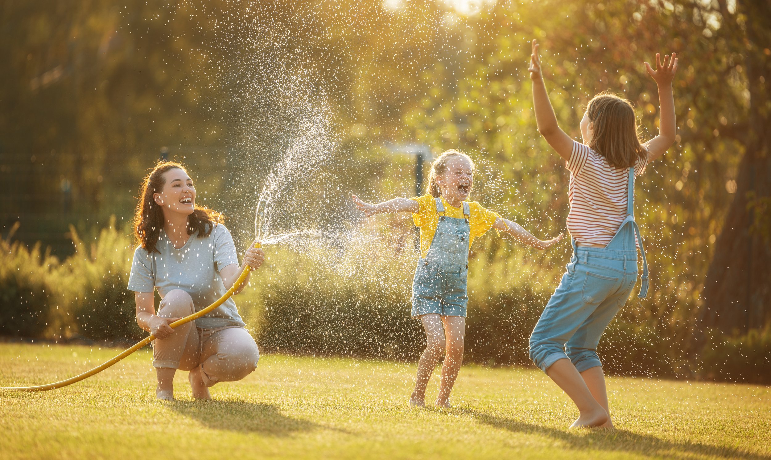 kids getting sprayed with a hose.jpeg