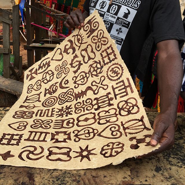 Master Adinkra printer Peter Boakye, experimenting with traditional stamps and ink on Ghanaian handmade paper.