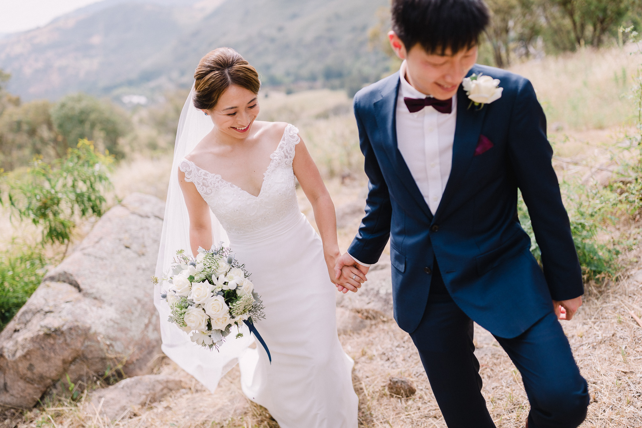 A bride and groom holding hands at Brindabella Hills Winery Wedding Photography