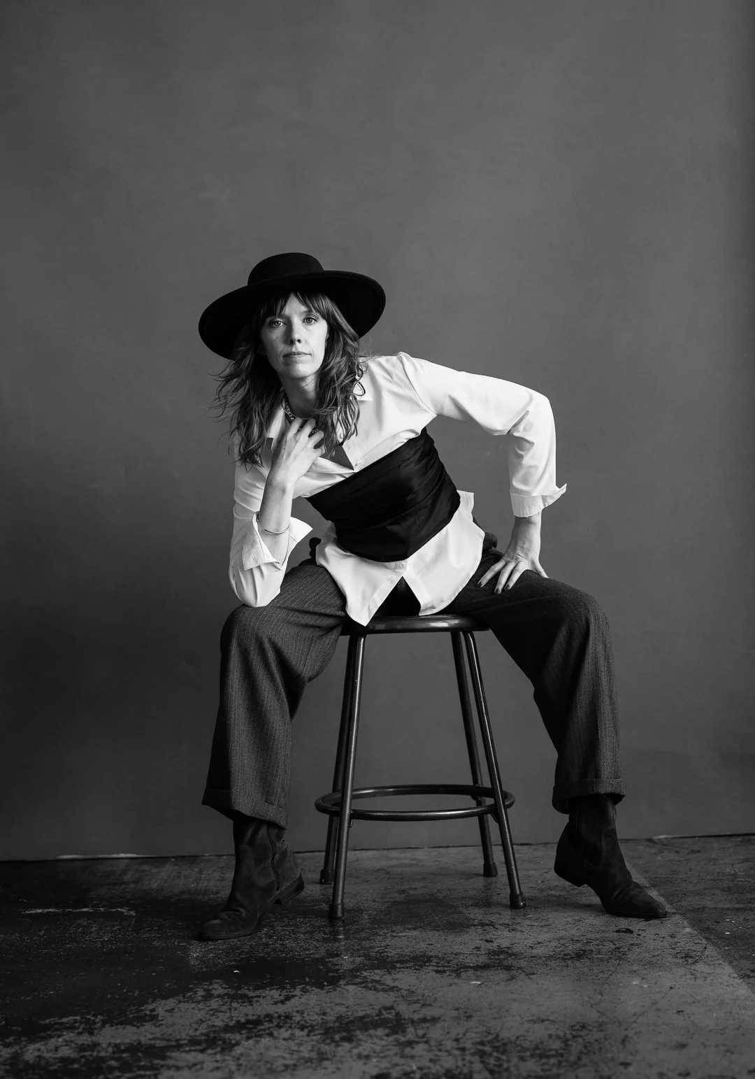 Midlife portrait photography of a confident woman taking up space looking at the camera