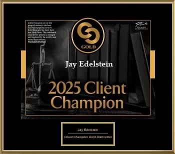Black-and-gold plaque reading “2025 Client Champion — Gold” with the name “Jay Edelstein,” set over scales of justice and law books.