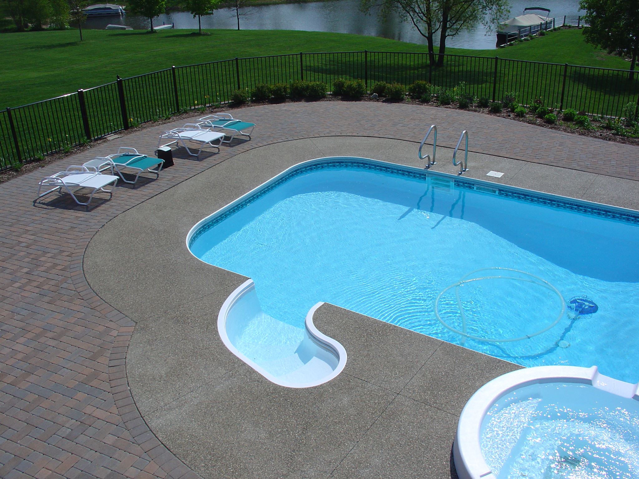 Outdoor kitchen, inground pool and concrete patio in Grosse Pointe Farms, Michigan