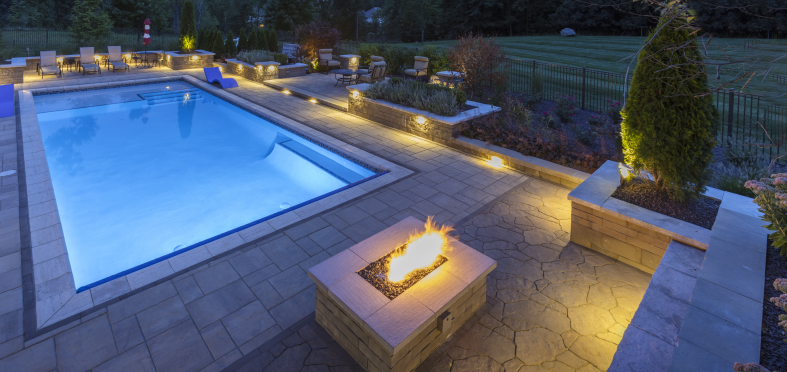 paver lighting around cool blue pool