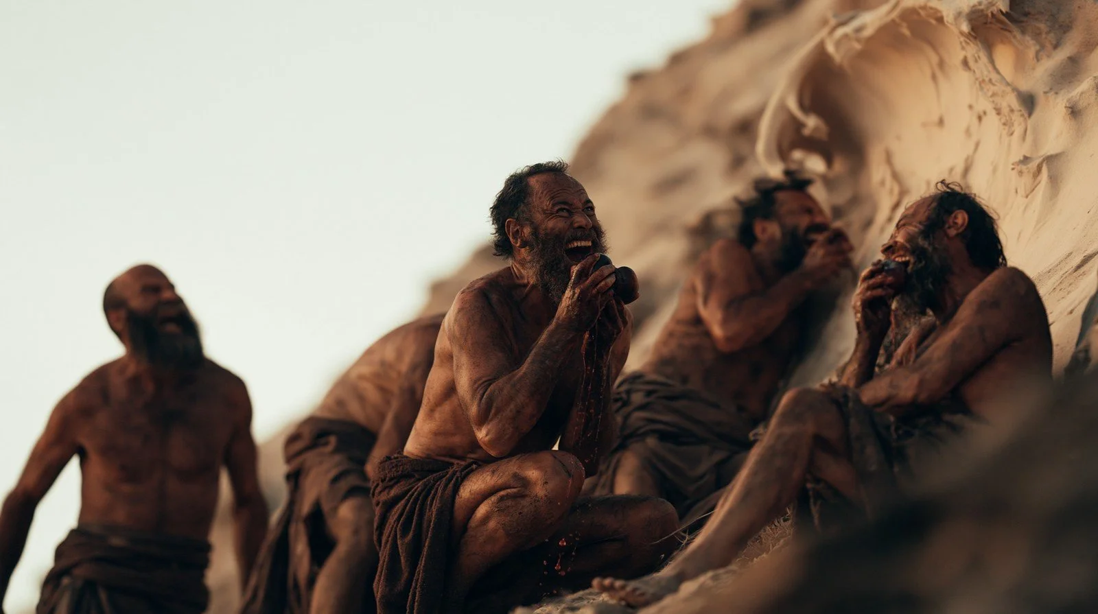 Visual-development image of the men gathered together on the sand