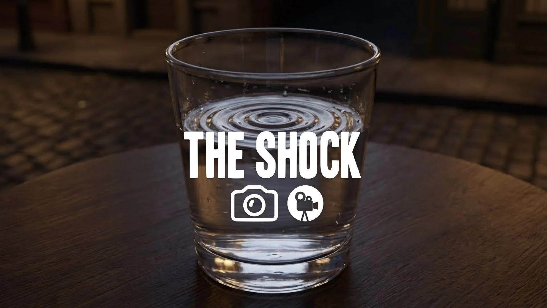 Tight close-up of a ripple forming in a glass of water due to heavy, rhythmic thumping nearby. Tension, vibrating surface, no music.