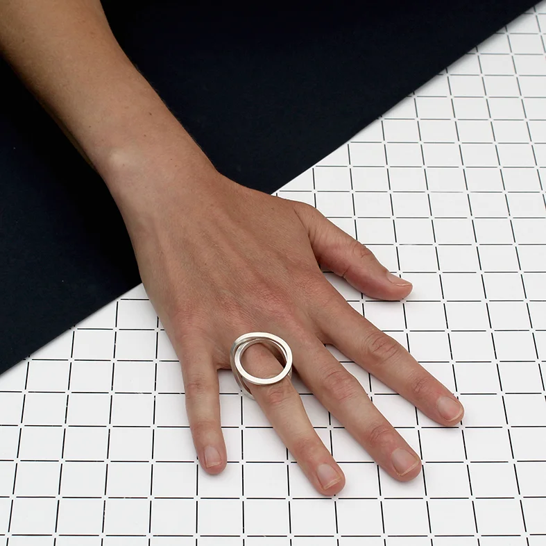 INFINITY RING (SHOWN HERE IN POLISHED STERLING SILVER) CAN BE WORN IN MULTIPLE POSITIONS. BRASS - £100 22 CARAT GOLD PLATED BRASS - £135 HALLMARKED STERLING SILVER - £150