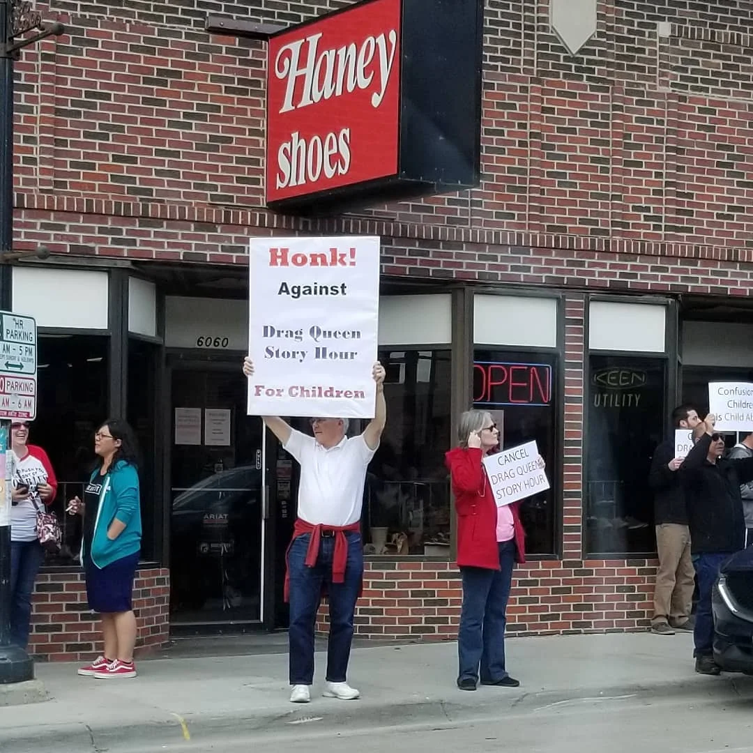 Signs held in opposition to Drag Queen Story Hour Photo: Kevin Flatowicz-Farmer