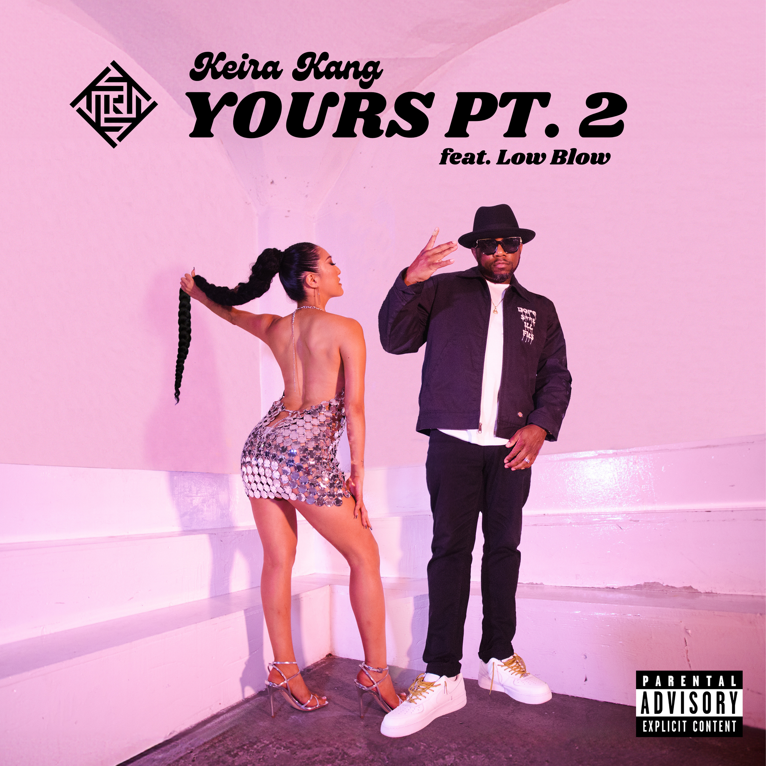 A female singer in a silver sequin dress and high heels posing near steps in pink stage lighting next to a male rapper.