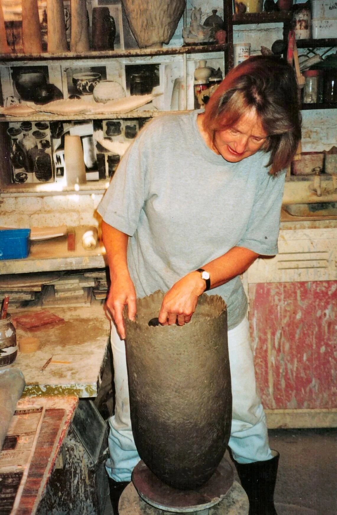 I am a vessel maker: whether thrown and altered or hand-built using slab, or pinch-and –coil. I often use non-ceramic additions to my pieces to emphasize a point. I have been working on practicality and exploring the paradoxical relationship of size linking pieces of a sculpture and pieces which suggest functionality, and are totally functional except for one aspect in the construction. With this in mind I have been making anchorstones and their suggestion of stability and safety ; this is perhaps why I continue to work in clay with pieces developing more for the idea than the process. My interest in wood-firing about 20 years ago with Raku firing: The exposure to wood ash and then smoke from the reduction created the random colours on the glazed surfaces, and in some cases natural lustres as well as textures. I continue to enjoy firing with wood, and the random effects it produces in conjunction with textures, rather that the rigidity of applied decoration. Some pieces have been fired to 1220C (Cone 6).in my small wood-fired kiln without additions to the kiln atmosphere: the remainder are fired in gas using the raku technique of post-firing reduction in shavings and paper.