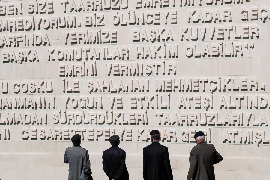 Four Turkish men visiting Chunuk Bair Mehmet Memorial, Gallipoli Peninsula Historical National Park, Gallipoli Peninsula, Turkey.